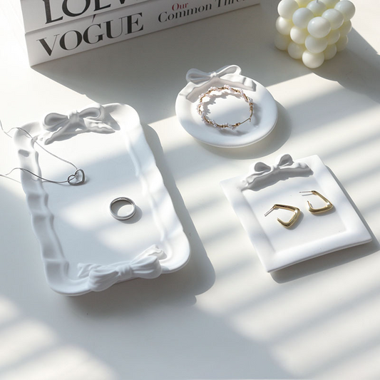 Rectangle, square and round white bow plaster trays styled with jewellery