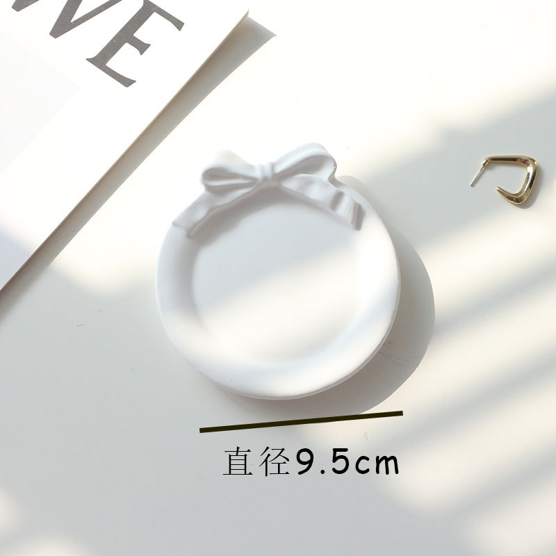 Round white bow plaster tray measuring approximately 9.5 centimetres in diameter