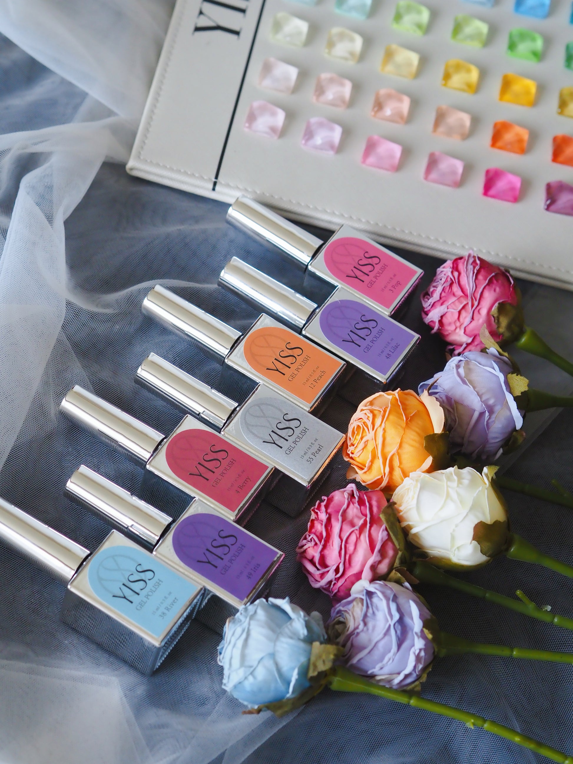 YISS gel polish bottles in front of colour swatch chart with roses