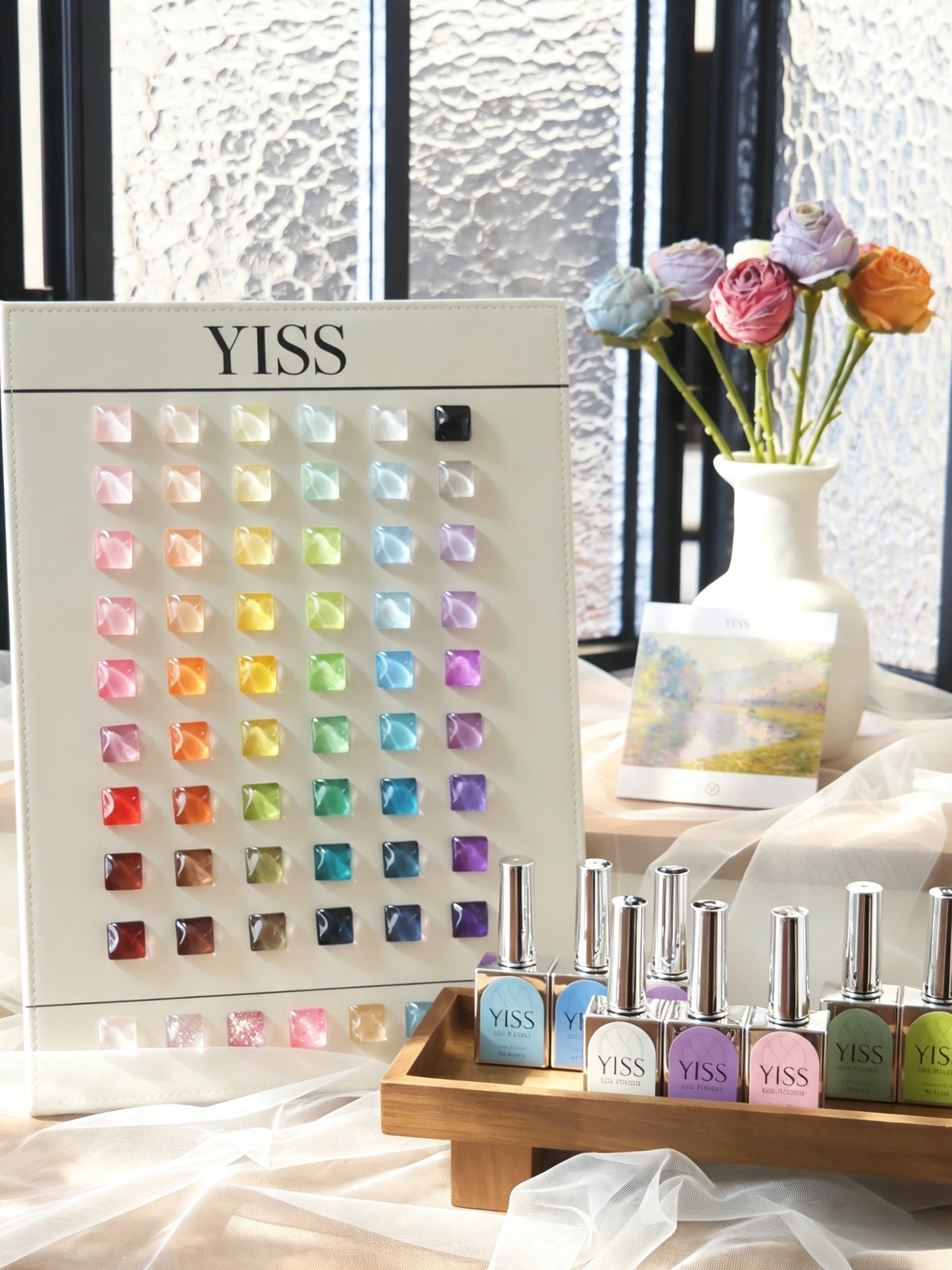 YISS Essential 60 Color Gel Polish Set with shade chart and bottles in a studio setting
